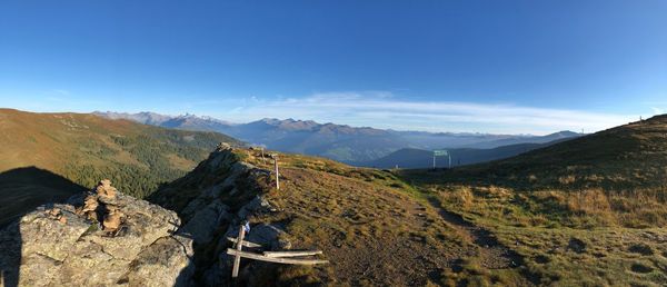 Panoramic view of mountains against blue sky