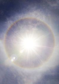 Low angle view of rainbow against sky on sunny day