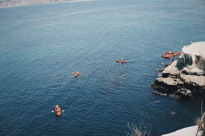 Aerial view of people kayaking in sea