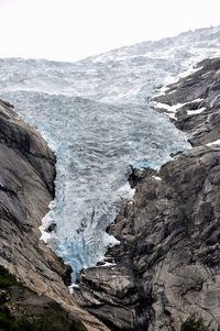 Scenic view of sea and mountain against sky