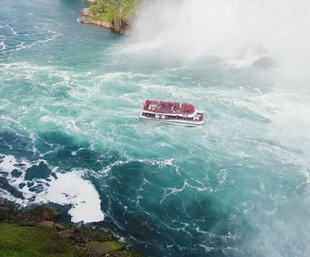 High angle view of red boat in sea against sky