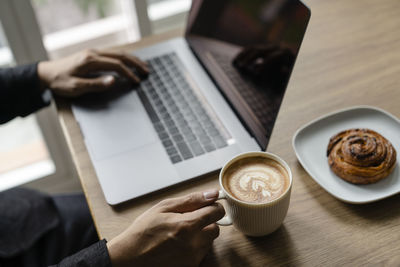 Midsection of coffee cup on table