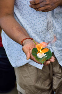 Midsection of man holding plant