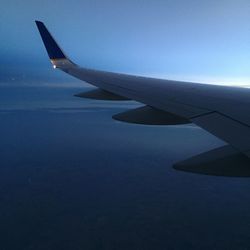 Cropped image of airplane flying over cloudscape