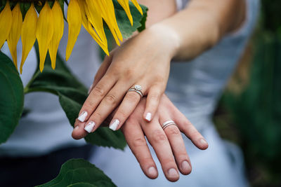 Midsection of couple holding hands