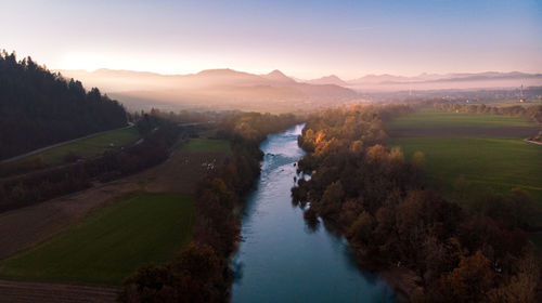 Scenic view of river amidst mountains against sky