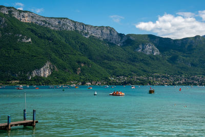 Scenic view of sea and mountains against sky