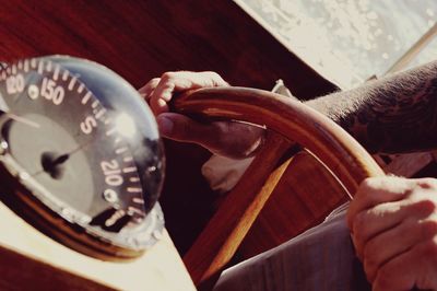 Close-up of man holding steering wheel