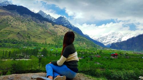 Man looking at mountain range against sky