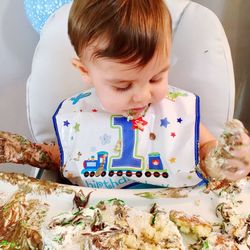 Close-up of baby eating birthday cake