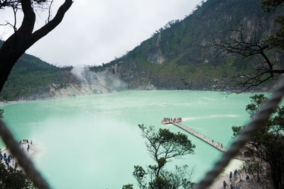 Scenic view of lake by trees against sky
