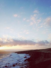 Scenic view of sea against sky at sunset