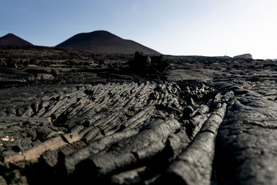 Scenic view of arid landscape against clear sky in volcano landscape. 