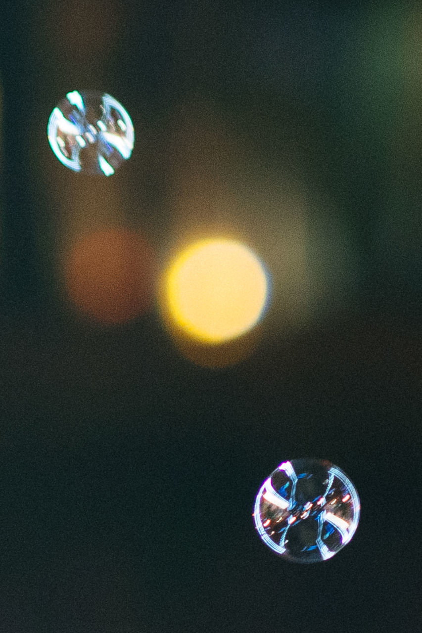 CLOSE-UP OF BUBBLES AGAINST WATER