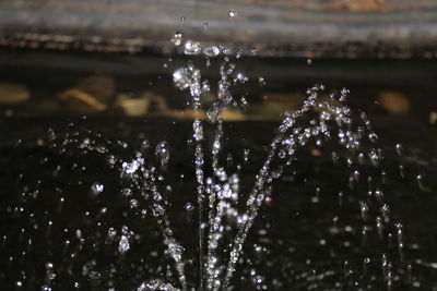 Close-up of water splashing in fountain at night