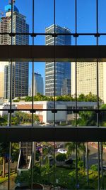 Buildings in city seen through glass window