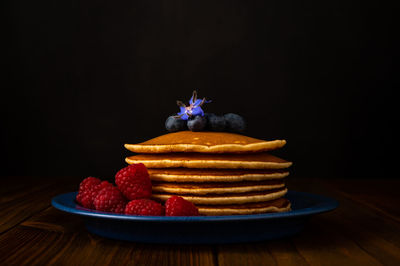 Close-up of strawberries on table against black background