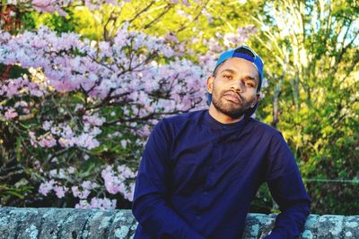 Portrait of man standing against trees