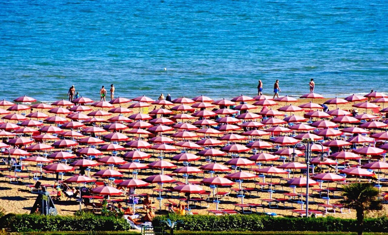 HIGH ANGLE VIEW OF PEOPLE AT SEA SHORE