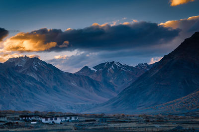 Scenic view of snowcapped mountains against sky during sunset