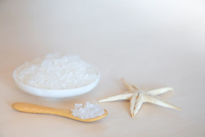 Close-up of starfish with salt in plate on table