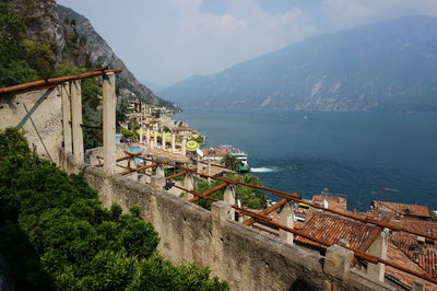 High angle view of buildings and sea against mountains