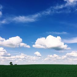 Scenic view of field against cloudy sky