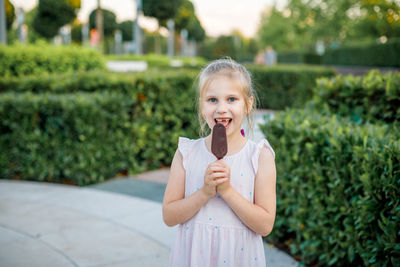 Portrait of smiling girl standing outdoors