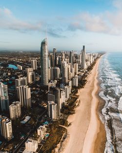 High angle view of buildings by sea against sky