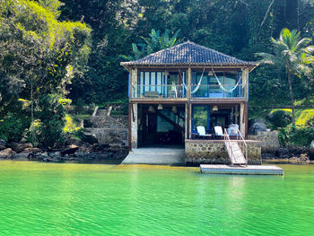 Scenic view of swimming pool by lake in forest