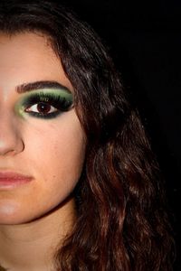 Close-up portrait of a beautiful young woman over black background