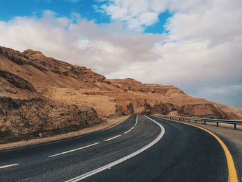 Empty road with mountains in background