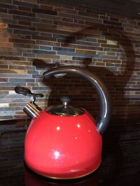 Close-up of red wine against wall at home