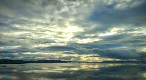 Scenic view of sea against storm clouds