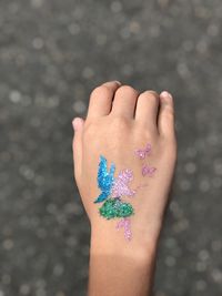 Cropped hand of child with sticker