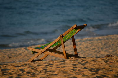 Empty deckchair on beach