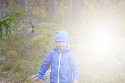 Portrait of boy standing on field 