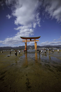 People at beach against sky