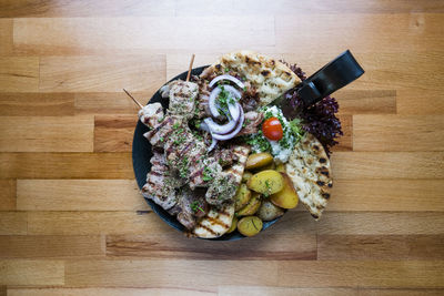 High angle view of various fruits in plate on table
