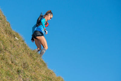 Girl running on the mountain peaks