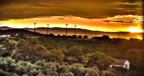 Scenic view of landscape against sky at sunset