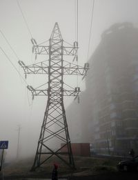 Low angle view of electricity pylon against sky