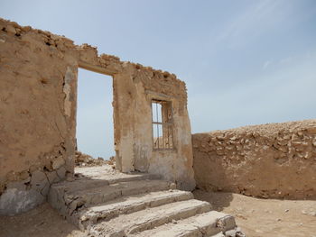 Old ruin in former fishing village against sky in qatar. 