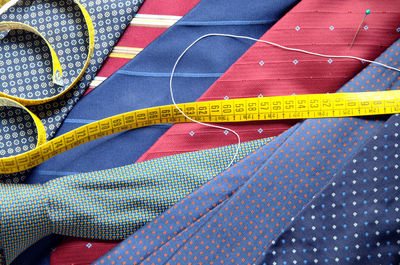 Close-up of colorful neckties with tape measure
