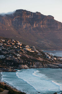 Scenic view of sea and mountains against sky