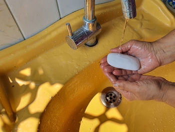 Close-up high angle view of hand holding water