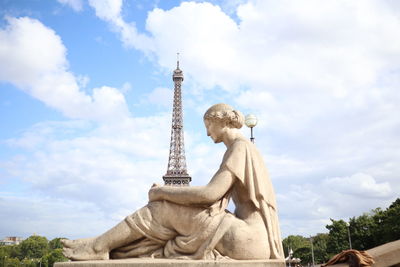 Low angle view of statue against cloudy sky