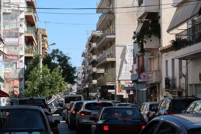 Traffic on road amidst buildings in city