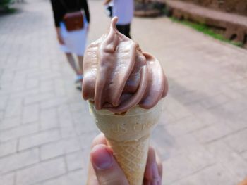 Hand holding ice cream cone