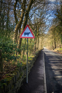 Road sign by trees